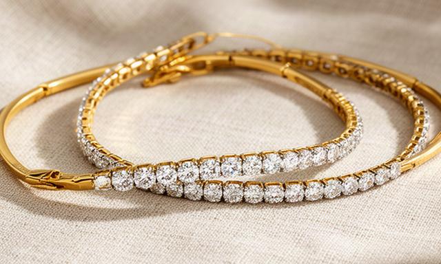 Slim gold bracelets and a diamond tennis bracelet on linen